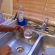 A resident of Flint, Mich., runs water from her faucet.
Al-Jazeera America screenshot